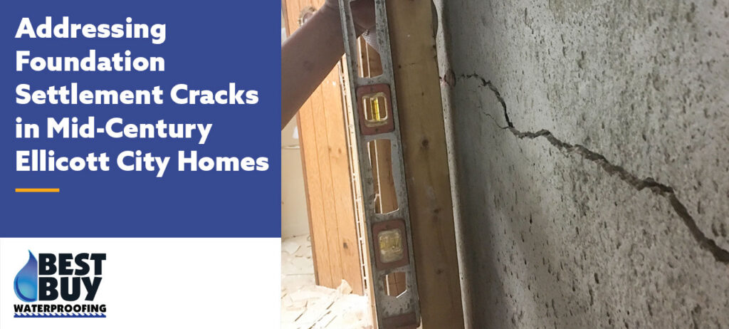Horizontal foundation settlement crack visible in a basement wall of a mid-century Ellicott City home, with a level positioned nearby to assess structural movement and foundation stability.