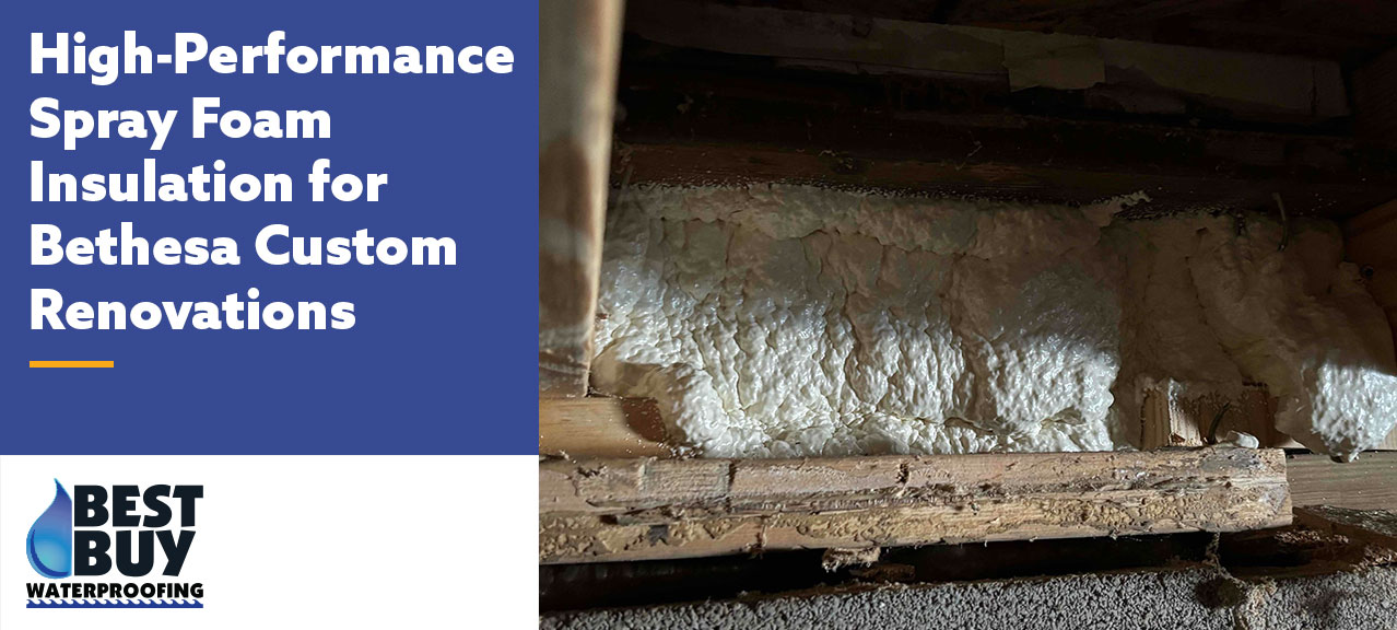 Spray foam insulation applied between floor joists in a crawl space beneath a Bethesda custom renovation project, creating an air-sealed and energy-efficient thermal barrier.